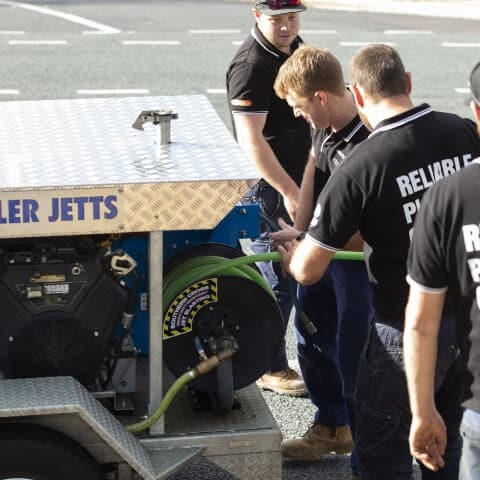 Water Tight Canberra team members ready the hose and plumbing equipment